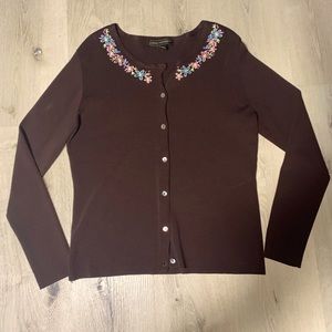 A brown button down sweater